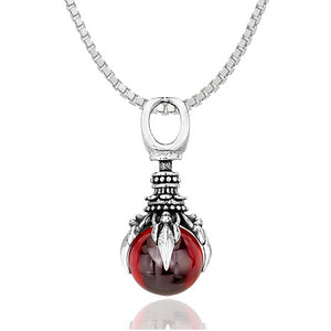 silver-toned oracle pendant holding a red crystal ball of harmony hanging from a box chain