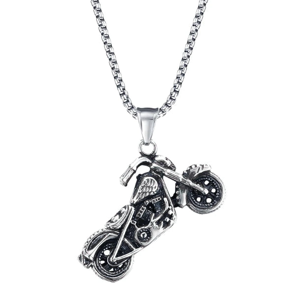 Motorcycle pendant hanging from silver chain necklace