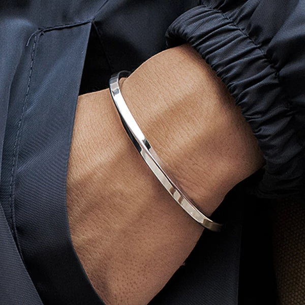 Twisted silver cuff bracelet on a man's wrist